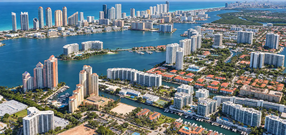 Aerial view of waterfront condominiums and waterways in Aventura, Florida